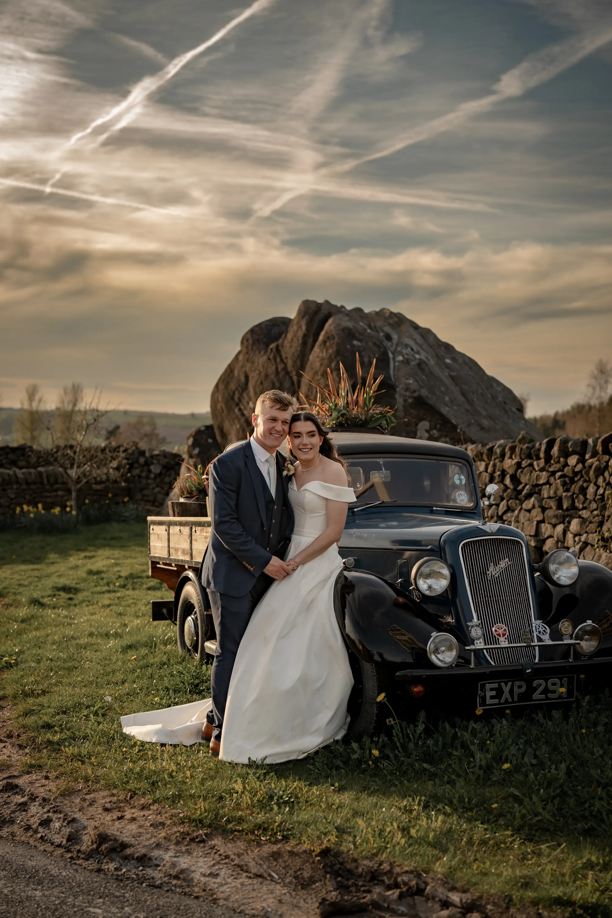 Couple silhouetted against the sky at golden hour
