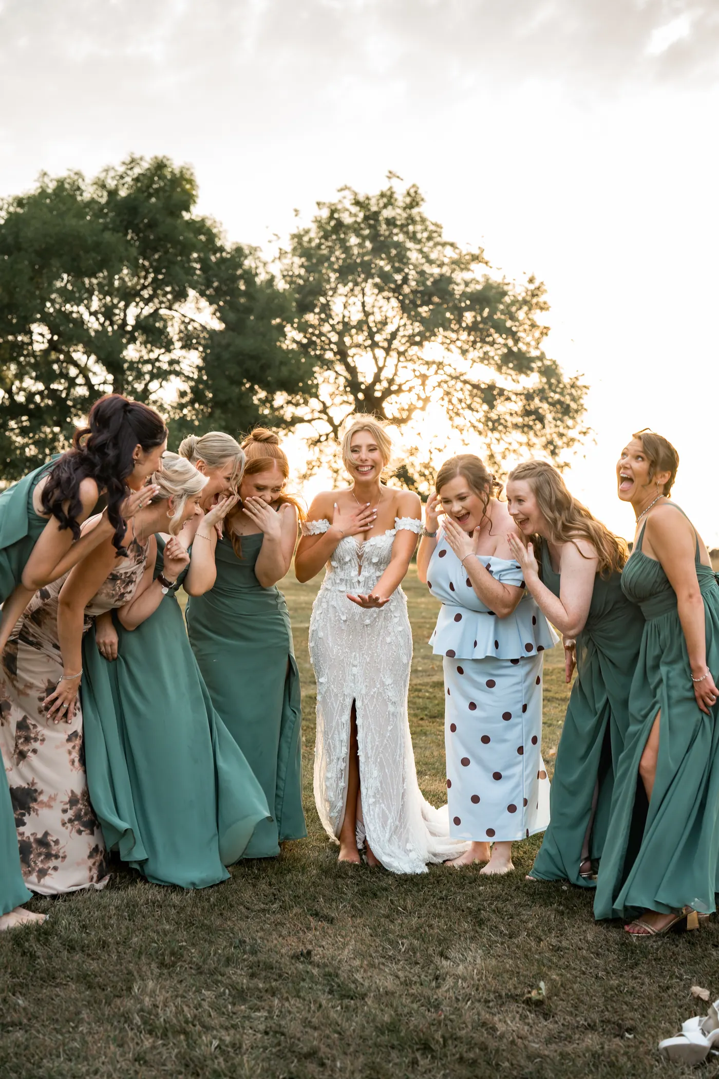 Bridal party in sage green dresses at golden hour