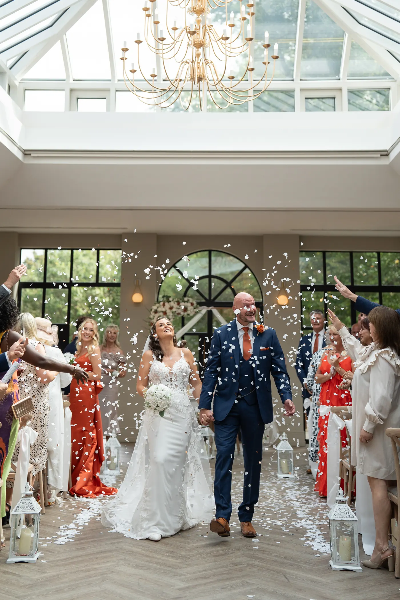 Wedding party walking through coloured smoke